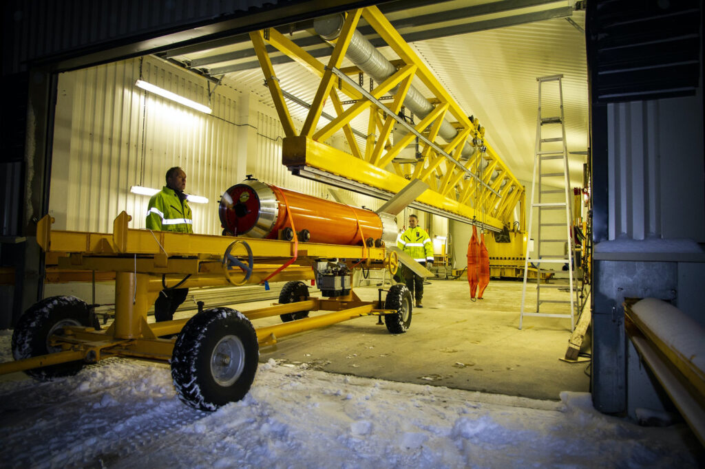 Photo of a rocket motor being transported on a trolly inside the launcher building.