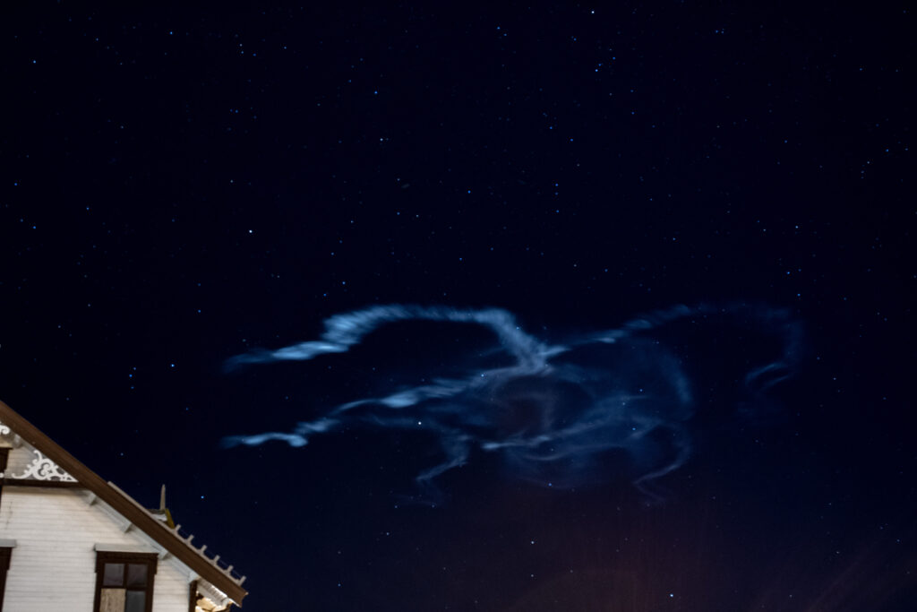 Image of a high altitude cloud against a dark, starry sky.