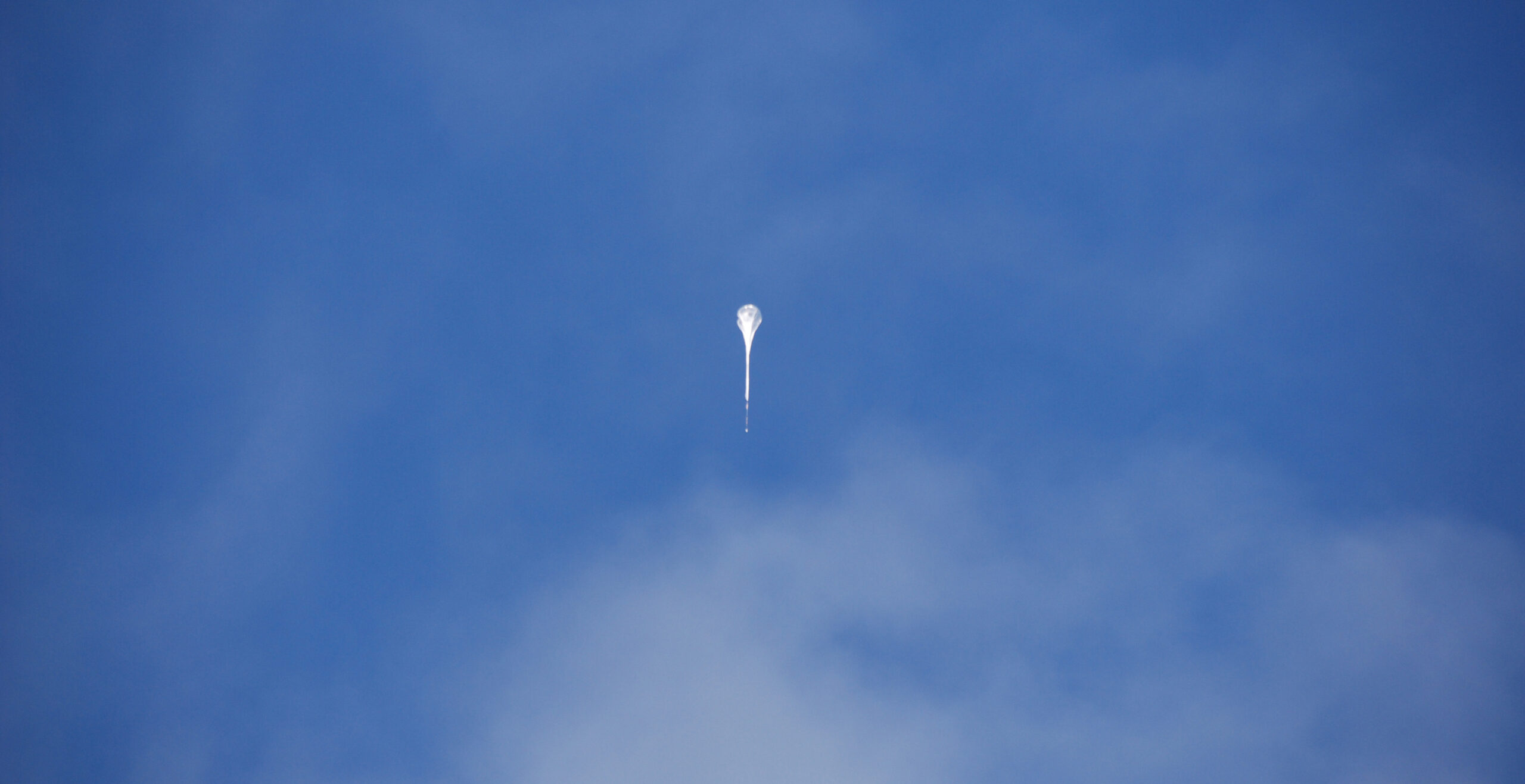 Photo of a stratospheric balloon ascending in the sky